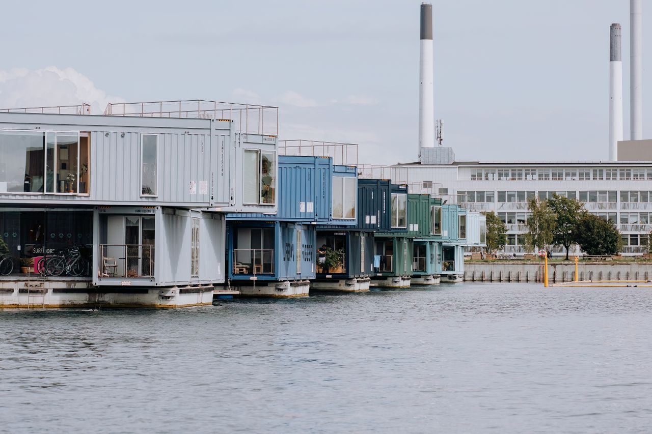 Innovative container homes on water, showcasing modern urban living in Copenhagen's harbor.